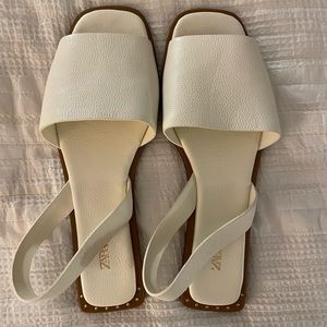 Women’s white flat leather sandals with heel strap